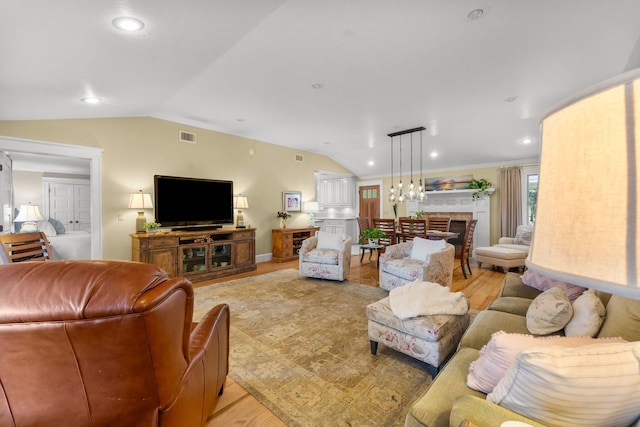 619 Pitts Bayshore Dr, Freeport, FL 32439 - living area featuring lofted ceiling, light wood-type flooring, a fireplace, and recessed lighting