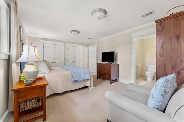 619 Pitts Bayshore Dr, Freeport, FL 32439 - bedroom featuring multiple closets, ornamental molding, carpet flooring, and ensuite bathroom