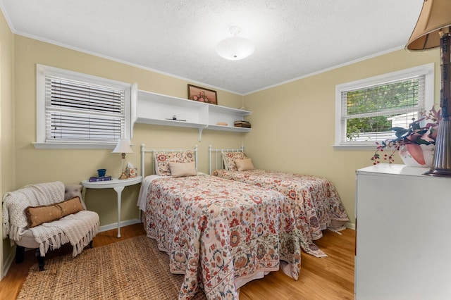 619 Pitts Bayshore Dr, Freeport, FL 32439 - bedroom with wood finished floors, ornamental molding, and a textured ceiling