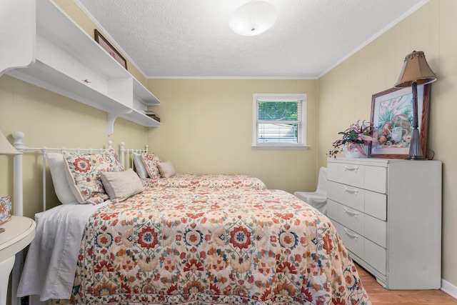 619 Pitts Bayshore Dr, Freeport, FL 32439 - bedroom featuring light wood-style flooring, ornamental molding, and a textured ceiling