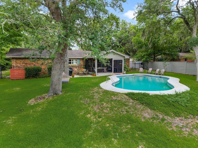 619 Pitts Bayshore Dr, Freeport, FL 32439 - view of swimming pool featuring a sunroom, a fenced backyard, and a patio