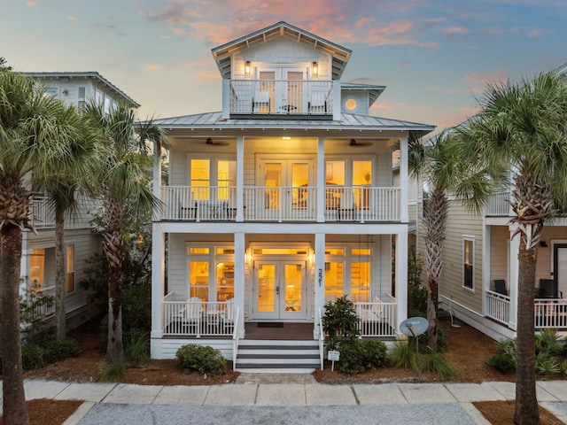 221 Seacrest Beach Blvd E, Seacrest, FL 32461 - view of front of property featuring a balcony, french doors, covered porch, a standing seam roof, and a metal roof