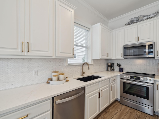 221 Seacrest Beach Blvd E, Seacrest, FL 32461 - kitchen with appliances with stainless steel finishes, white cabinetry, ornamental molding, decorative backsplash, and wood finished floors