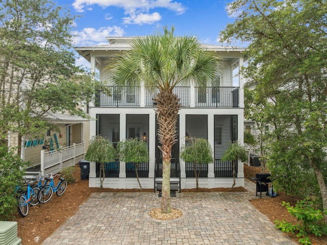221 Seacrest Beach Blvd E, Seacrest, FL 32461 - rear view of house with a balcony and a sunroom