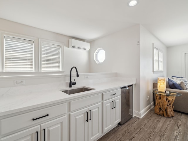 221 Seacrest Beach Blvd E, Seacrest, FL 32461 - kitchen featuring a wall unit AC, wood finished floors, white cabinetry, light countertops, and fridge