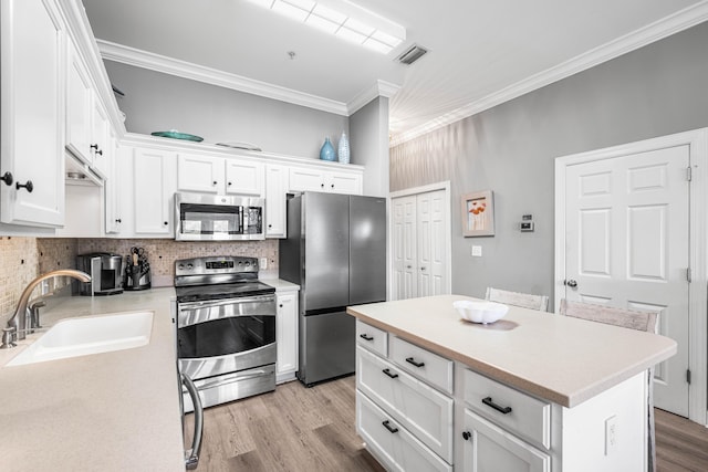 231 Somerset Bridge Rd Unit 2307, Santa Rosa Beach, FL 32459 - kitchen with appliances with stainless steel finishes, a sink, crown molding, tasteful backsplash, and white cabinetry