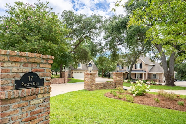 17 Poquito Rd, Shalimar, FL 32579 - view of green lawn featuring concrete driveway and a garage