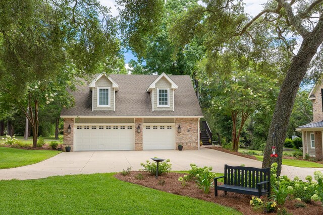 17 Poquito Rd, Shalimar, FL 32579 - cape cod house featuring a garage, a shingled roof, brick siding, and driveway