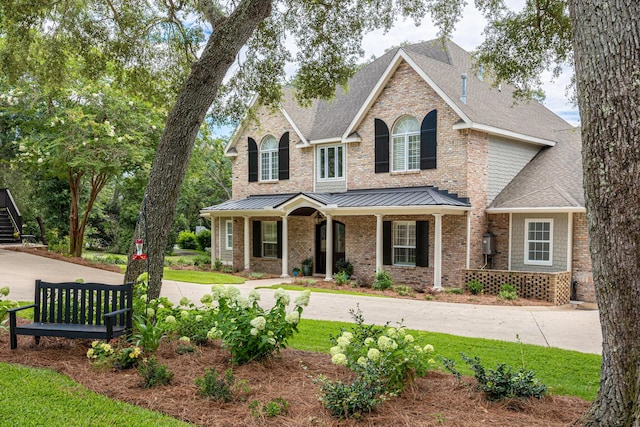17 Poquito Rd, Shalimar, FL 32579 - view of front of property featuring covered porch, a standing seam roof, roof with shingles, and brick siding