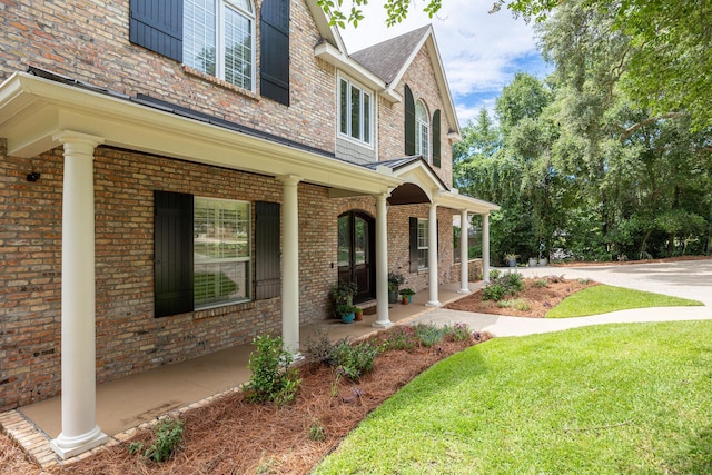 17 Poquito Rd, Shalimar, FL 32579 - view of home's exterior featuring covered porch, brick siding, and a lawn