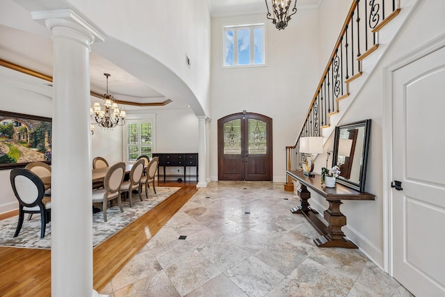 17 Poquito Rd, Shalimar, FL 32579 - foyer with a chandelier, decorative columns, crown molding, arched walkways, and stairway