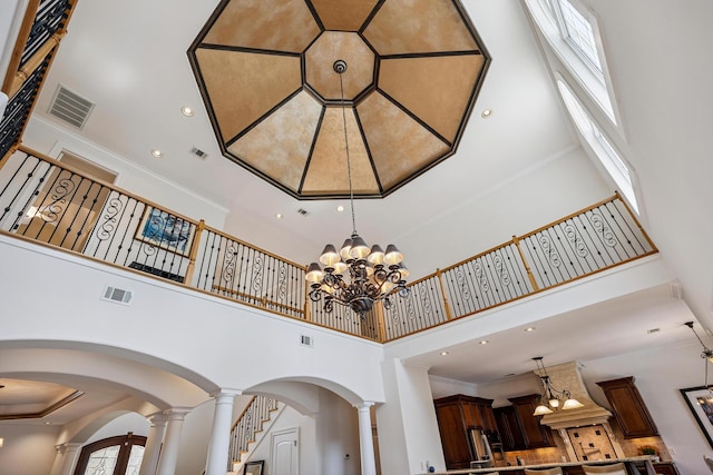 17 Poquito Rd, Shalimar, FL 32579 - detailed view of a chandelier, arched walkways, ornate columns, recessed lighting, and custom exhaust hood