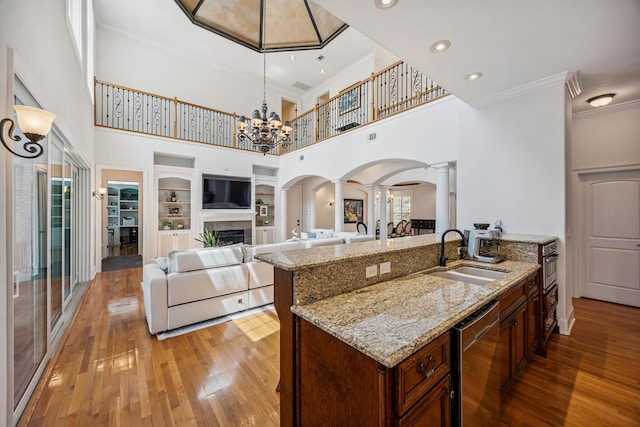 17 Poquito Rd, Shalimar, FL 32579 - kitchen featuring decorative columns, arched walkways, open floor plan, ornamental molding, and light wood-type flooring