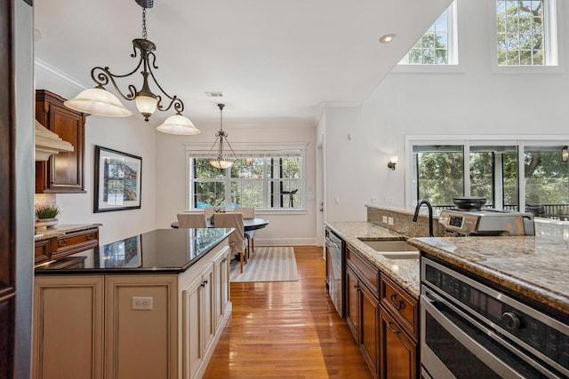 17 Poquito Rd, Shalimar, FL 32579 - kitchen featuring light wood finished floors, appliances with stainless steel finishes, plenty of natural light, dark stone countertops, and ornamental molding