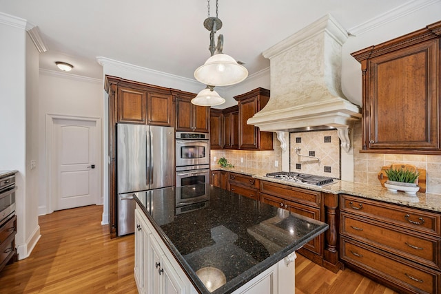 17 Poquito Rd, Shalimar, FL 32579 - kitchen with appliances with stainless steel finishes, light wood-type flooring, custom range hood, backsplash, and crown molding