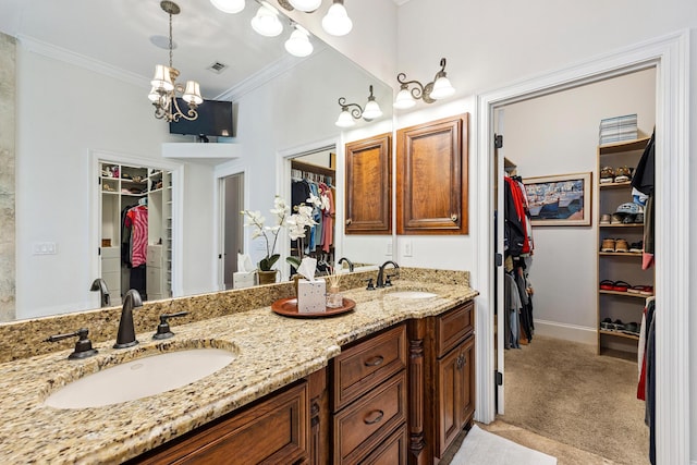 17 Poquito Rd, Shalimar, FL 32579 - bathroom featuring a spacious closet, double vanity, ornamental molding, and a chandelier