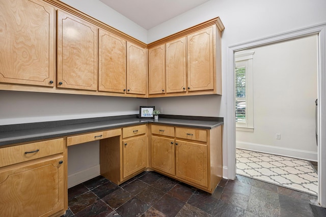 17 Poquito Rd, Shalimar, FL 32579 - kitchen with dark countertops, dark stone finish floors, and built in desk