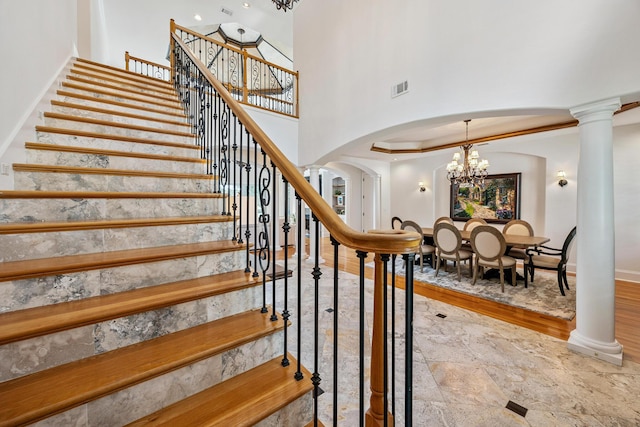 17 Poquito Rd, Shalimar, FL 32579 - stairs featuring a chandelier, a towering ceiling, arched walkways, and stone finish floors