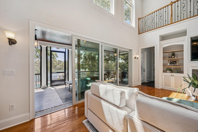 17 Poquito Rd, Shalimar, FL 32579 - living room featuring plenty of natural light, wood finished floors, built in shelves, and a high ceiling