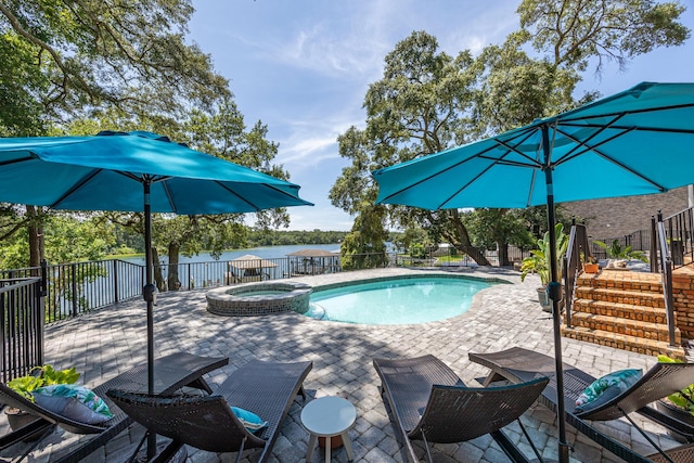 17 Poquito Rd, Shalimar, FL 32579 - view of swimming pool featuring a pool with connected hot tub, a patio, and a water view