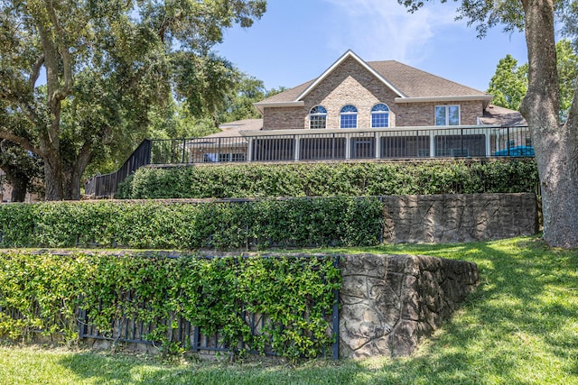 17 Poquito Rd, Shalimar, FL 32579 - back of house featuring brick siding, a lawn, and a shingled roof