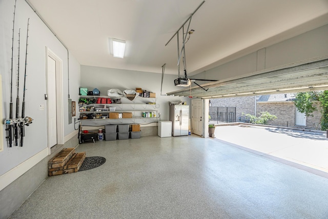 17 Poquito Rd, Shalimar, FL 32579 - garage with white refrigerator with ice dispenser and a garage door opener