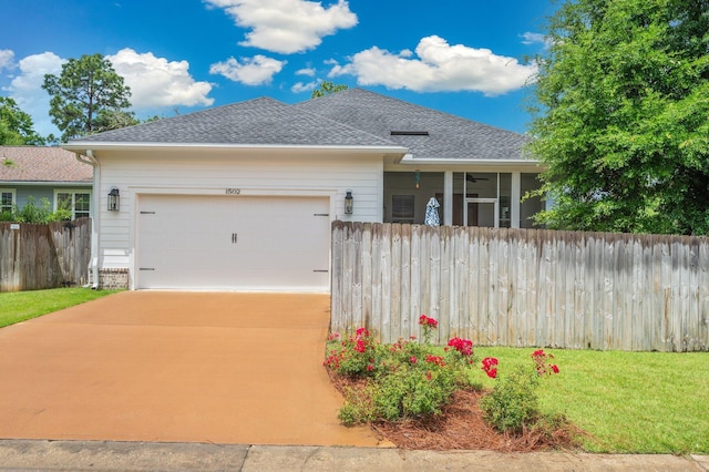 1502 Coriander Ln, Niceville, FL 32578 - ranch-style house with a garage, a shingled roof, a sunroom, and concrete driveway