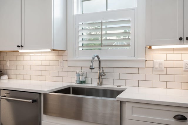 1502 Coriander Ln, Niceville, FL 32578 - kitchen with dishwasher, tasteful backsplash, and white cabinetry
