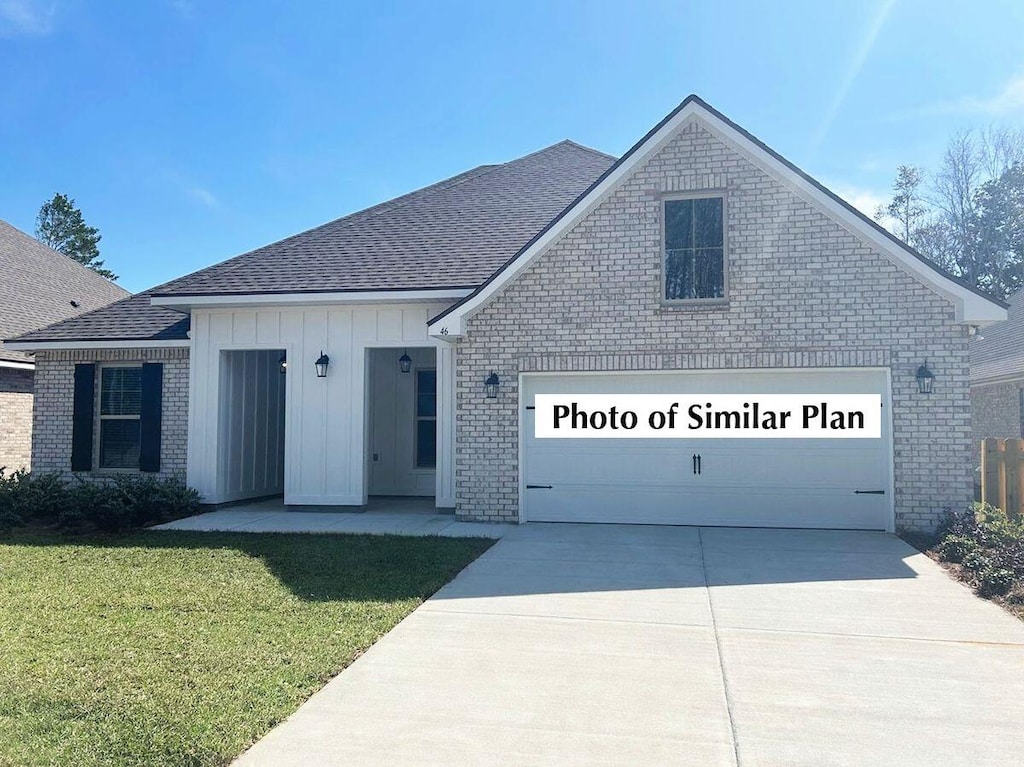 2743 Louis Cir, Crestview, FL 32536 - view of front of home featuring brick siding, driveway, and roof with shingles