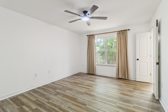 51 Yearling Ct, Defuniak Springs, FL 32433 - unfurnished room with light wood-type flooring, a ceiling fan, and a textured ceiling