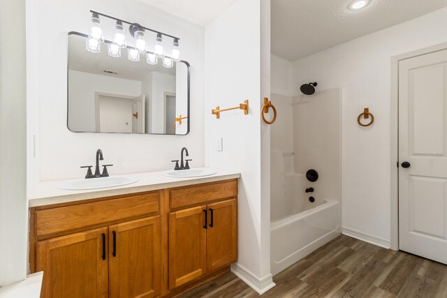 51 Yearling Ct, Defuniak Springs, FL 32433 - full bath featuring wood finished floors, double vanity, and shower / tub combination