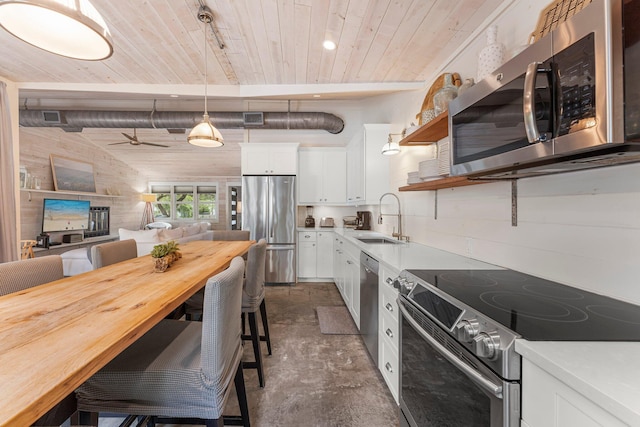 81 Canal St, Santa Rosa Beach, FL 32459 - kitchen featuring appliances with stainless steel finishes, wood ceiling, white cabinetry, a breakfast bar area, and open shelves