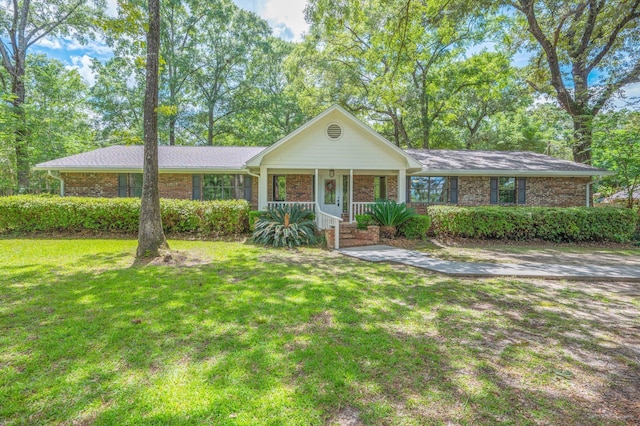 6060 Bud Moulton Rd, Crestview, FL 32536 - single story home featuring a front yard, covered porch, and brick siding