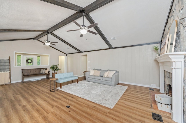 6060 Bud Moulton Rd, Crestview, FL 32536 - living room with a ceiling fan, light wood-style floors, and a fireplace with raised hearth