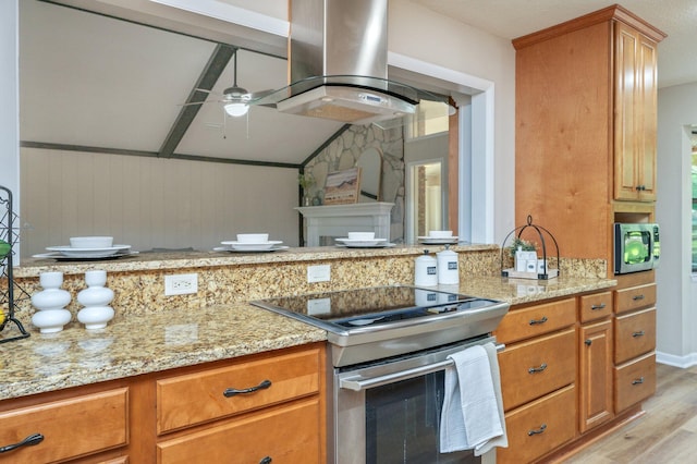 6060 Bud Moulton Rd, Crestview, FL 32536 - kitchen featuring stainless steel appliances, light wood finished floors, light stone countertops, and brown cabinets