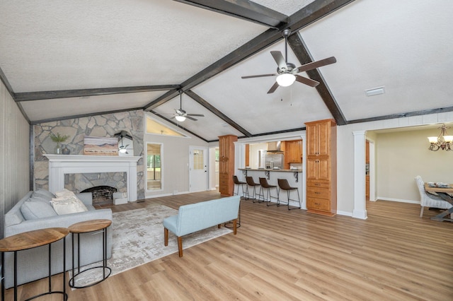 6060 Bud Moulton Rd, Crestview, FL 32536 - living room featuring ceiling fan, light wood-style flooring, a stone fireplace, and a chandelier