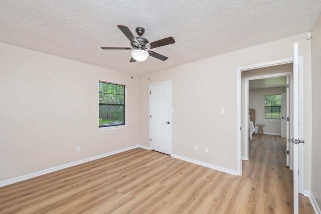 6060 Bud Moulton Rd, Crestview, FL 32536 - unfurnished room with light wood-type flooring, plenty of natural light, ceiling fan, and a textured ceiling