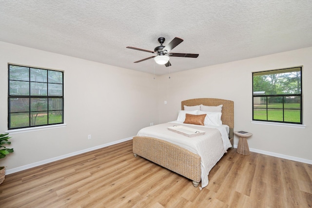 6060 Bud Moulton Rd, Crestview, FL 32536 - bedroom featuring light wood-type flooring, a textured ceiling, and ceiling fan