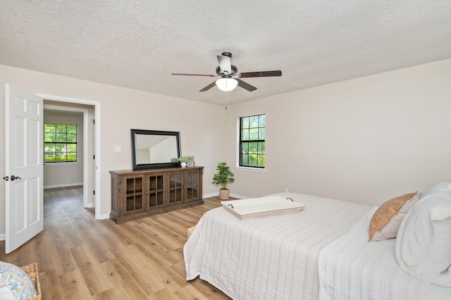 6060 Bud Moulton Rd, Crestview, FL 32536 - bedroom with light wood-type flooring, a textured ceiling, and a ceiling fan