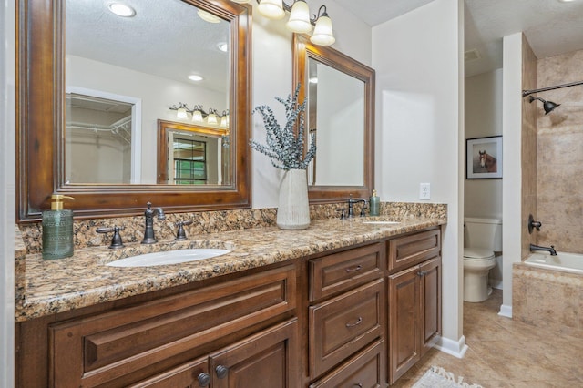 6060 Bud Moulton Rd, Crestview, FL 32536 - bathroom featuring double vanity, tile patterned flooring, washtub / shower combination, and a textured ceiling