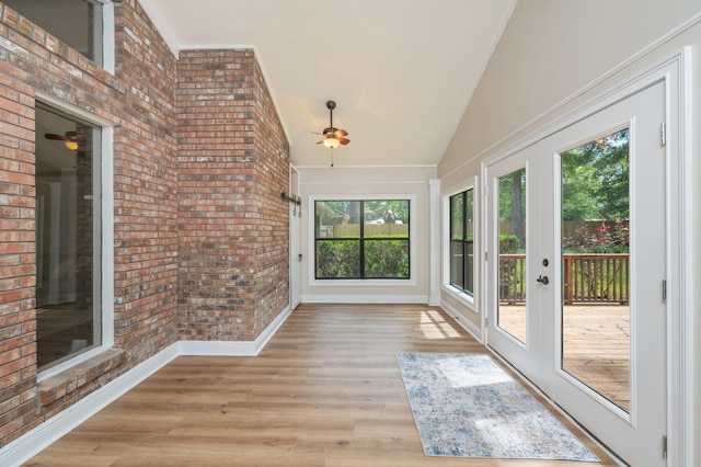 6060 Bud Moulton Rd, Crestview, FL 32536 - unfurnished sunroom with brick wall, wood finished floors, french doors, and high vaulted ceiling