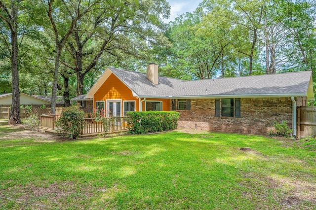 6060 Bud Moulton Rd, Crestview, FL 32536 - back of house featuring a chimney, a wooden deck, brick siding, and a shingled roof