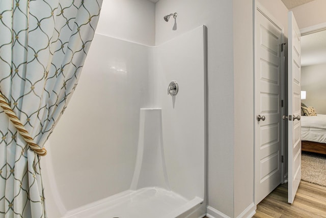 2889A Patriot Ridge Dr, Crestview, FL 32539 - full bathroom with connected bathroom, curtained shower, wood finished floors, and baseboards