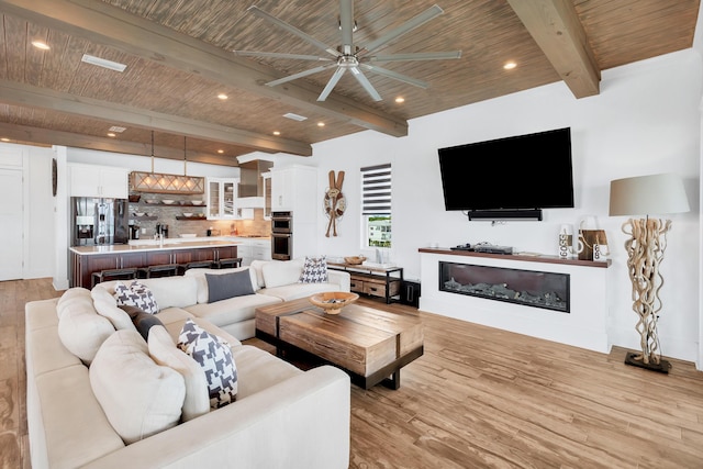 64 S Emerald Cove Ln, Inlet Beach, FL 32461 - living area with a ceiling fan, light wood-type flooring, a wooden ceiling with exposed beams, a glass covered fireplace, and recessed lighting
