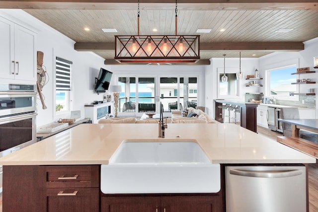 64 S Emerald Cove Ln, Inlet Beach, FL 32461 - kitchen with appliances with stainless steel finishes, open floor plan, a wood ceiling with exposed beams, light countertops, and decorative light fixtures