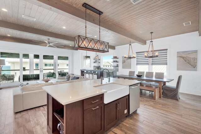 64 S Emerald Cove Ln, Inlet Beach, FL 32461 - kitchen with stainless steel dishwasher, open floor plan, light wood-type flooring, dark brown cabinets, and a wooden ceiling with exposed beams