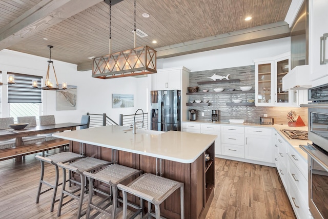 64 S Emerald Cove Ln, Inlet Beach, FL 32461 - kitchen with appliances with stainless steel finishes, open shelves, a wood ceiling with exposed beams, tasteful backsplash, and an island with sink