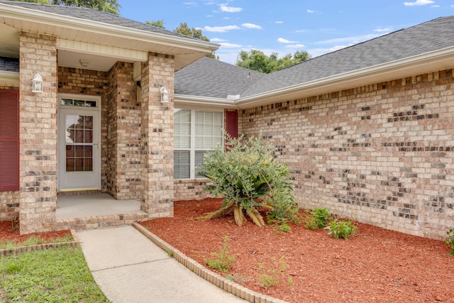 2124 Hagood Loop, Crestview, FL 32536 - view of exterior entry featuring roof with shingles and brick siding