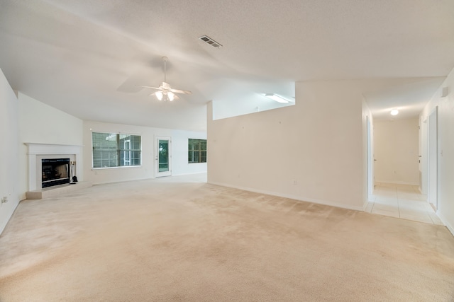 2124 Hagood Loop, Crestview, FL 32536 - unfurnished living room featuring light carpet, lofted ceiling, a ceiling fan, and a fireplace with raised hearth