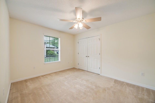 2124 Hagood Loop, Crestview, FL 32536 - unfurnished bedroom featuring light colored carpet, a closet, and a ceiling fan